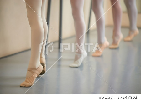 Little ballerina legs in pointe shoes. 57247802