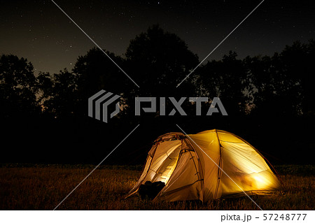 Traveling and camping concept - camp tent at night Traveling and camping concept - camp tent at night 57248777