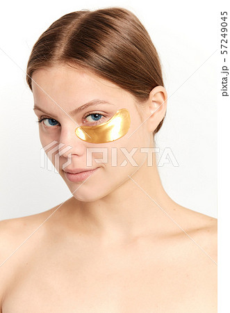 young beautiful cheerful girl experimenting with a patch under eyes young beautiful cheerful girl experimenting with a patch under eyes 57249045