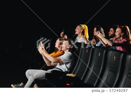 young people trying to catch the interesting moment with phones 57249297