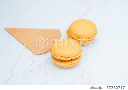 Fun flat lay composition of macarons and a cookie Fun flat lay composition of macarons and a cookie 57250717