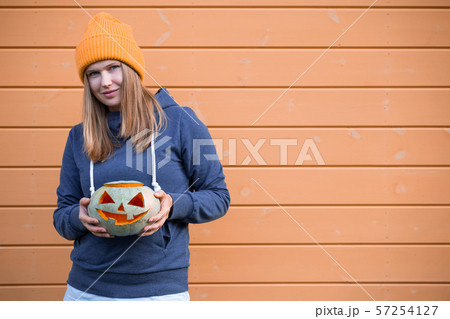 Woman holding Halloween pumpkin 57254127