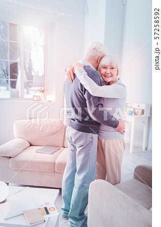 Stylish elderly lady wearing blue sweater dancing with husband Stylish elderly lady wearing blue sweater dancing with husband 57258592