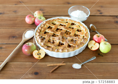 close up of apple pie on wooden table 57258883