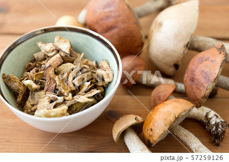 dried mushrooms in bowl on wooden background dried mushrooms in bowl on wooden background 57259126