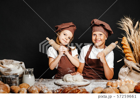 Adorable girl with brother cooking 57259661