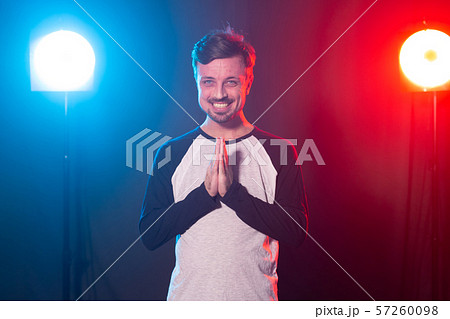 Portrait of man keeps palms together, has pleased expression. Glad attractive male makes request Portrait of man keeps palms together, has pleased expression. Glad attractive male makes request 57260098