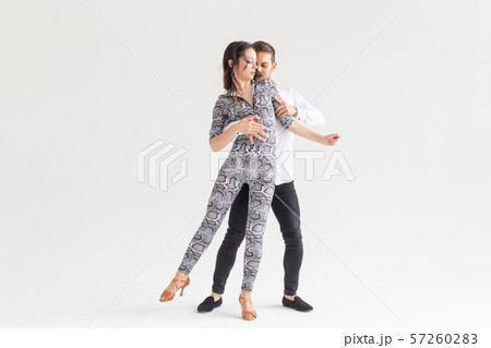 Social dance, kizomba, tango, salsa, people concept - beautiful couple dancing bachata on white 57260283