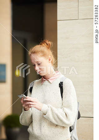 Contemporary Young Woman Using Smartphone Outdoors Contemporary Young Woman Using Smartphone Outdoors 57263382