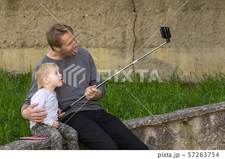 Father and son doing selfie Father and son doing selfie 57263754