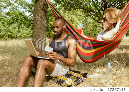 Young multiethnic international couple outdoors Young multiethnic international couple outdoors 57267153