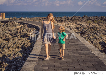 Mom and son travelers on amazing Nusadua, Waterbloom Fountain, Bali Island Indonesia. Traveling with Mom and son travelers on amazing Nusadua, Waterbloom Fountain, Bali Island Indonesia. Traveling with 57267905