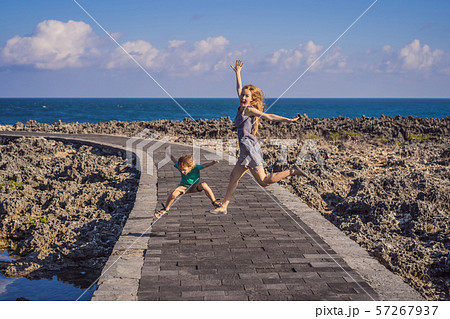 Mom and son travelers on amazing Nusadua, Waterbloom Fountain, Bali Island Indonesia. Traveling with 57267937