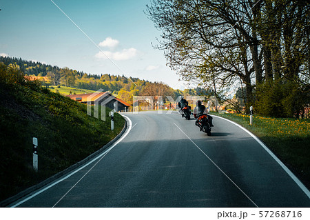 Two biker riding alone on mountainous road 57268716