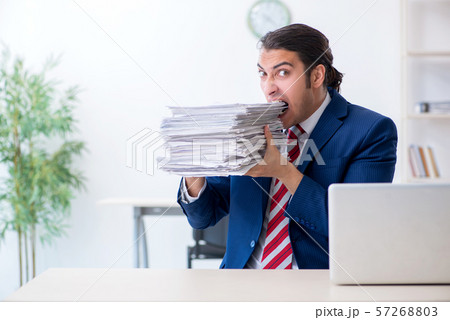 Young male businessman sitting in the office 57268803