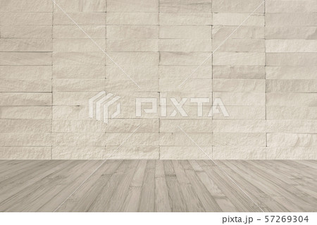 Cream beige rock tile wall with wooden floor in light sepia brown color for interior background... 57269304