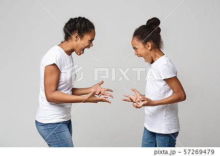 Furious african sisters screaming at each other 57269479