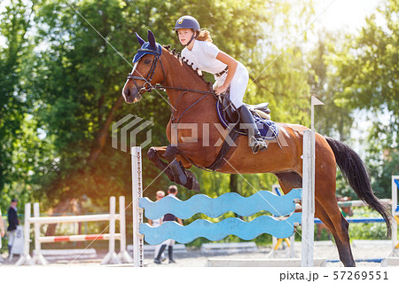 Horse rider woman on show jumping competition 57269551