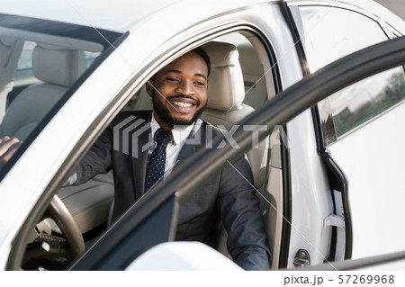 Handsome afro businessman getting out of car Handsome afro businessman getting out of car 57269968