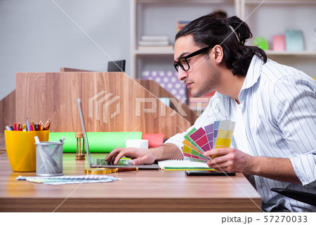 Young male designer working in the office Young male designer working in the office 57270033