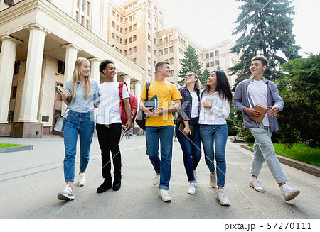 Free time of students. Friendly students walking after classes Free time of students. Friendly students walking after classes 57270111