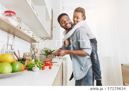 Daddy and daughter enjoying their time at kitchen 57270624