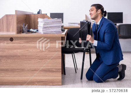 Young handsome businessman working in the office Young handsome businessman working in the office 57270638