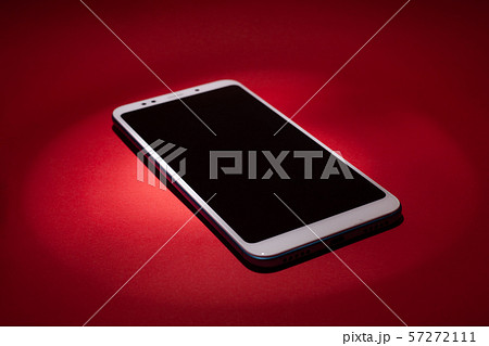 Smart phone on red background with copyspace. 57272111