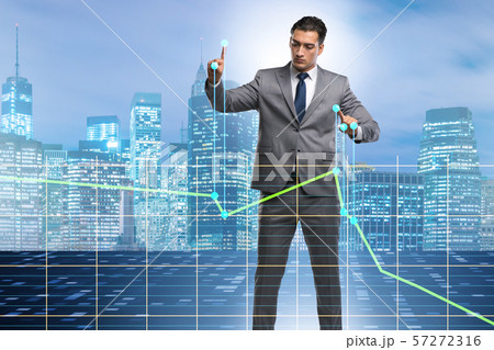 Businessman controlling the market with strings 57272316