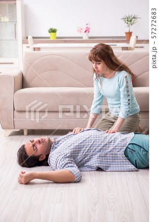 Young couple in first aid concept at home 57272683