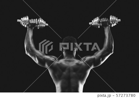 Back view of afro sportsman pushing dumbbells up Back view of afro sportsman pushing dumbbells up 57273780