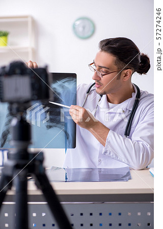 Young male doctor radiologist recording video for his blog 57274246