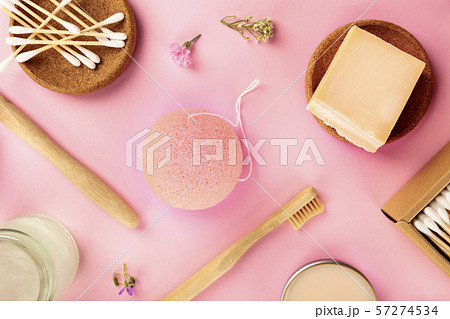 Plastic-free, zero waste cosmetics, flat lay on a pink background. Bamboo toothbrushes and cotton Plastic-free, zero waste cosmetics, flat lay on a pink background. Bamboo toothbrushes and cotton 57274534