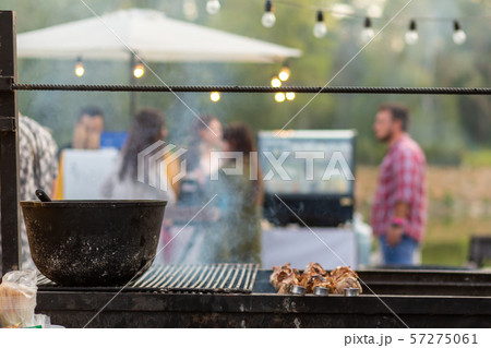 The cook fries juicy steaming meat on a charcoal 57275061