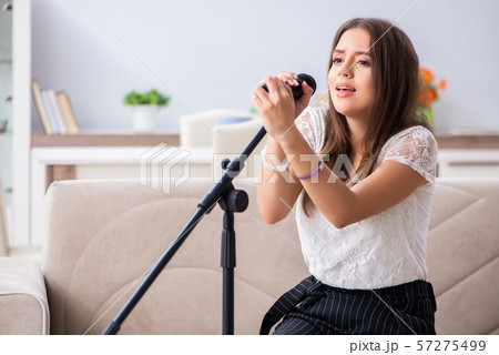 Female beautiful musician singing at home Female beautiful musician singing at home 57275499