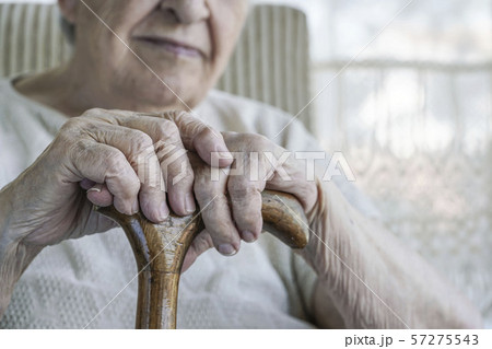 wrinkled hand of a senior woman on cane wrinkled hand of a senior woman on cane 57275543