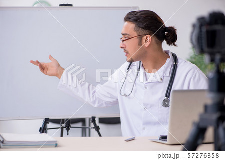 Young male doctor recording video for his blog 57276358