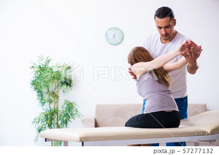 Young woman visiting male doctor physiotherapist Young woman visiting male doctor physiotherapist 57277132