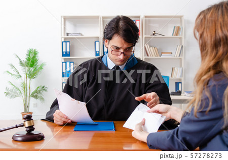 Young woman visiting male lawyer Young woman visiting male lawyer 57278273
