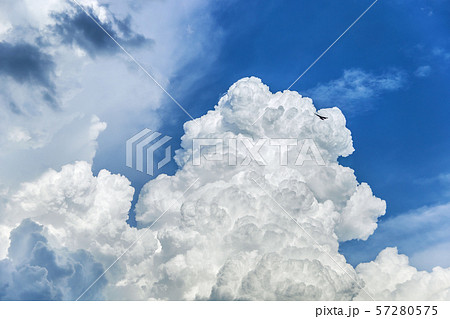 Stunning huge bizarre clouds swirl in the blue sky. Image for backgrounds. Stunning huge bizarre clouds swirl in the blue sky. Image for backgrounds. 57280575