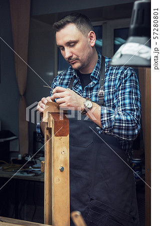 Concept of handmade craft production of leather goods. Concept of handmade craft production of leather goods. 57280801