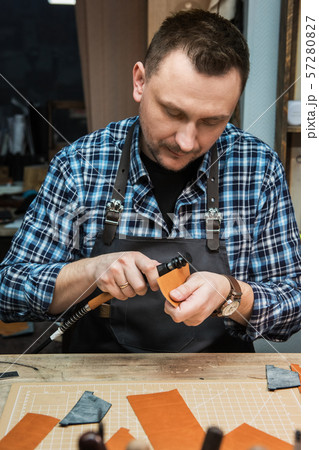 Concept of handmade craft production of leather goods. Concept of handmade craft production of leather goods. 57280827