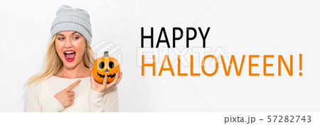 Happy Halloween with woman holding a pumpkin Happy Halloween with woman holding a pumpkin 57282743