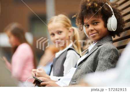 Schoolboy with his classmate outdoors 57282915