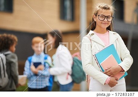 Schoolgirl with books at school 57283107