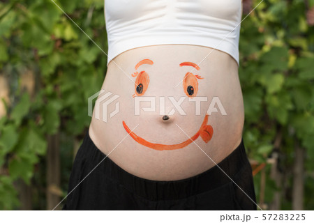 Belly of a pregnant woman with a painted smiling Belly of a pregnant woman with a painted smiling 57283225