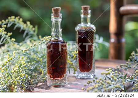 Bottles of herbal tincture with blooming wormwood 57283324