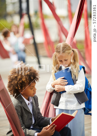 School classmates with books outdoors School classmates with books outdoors 57283361