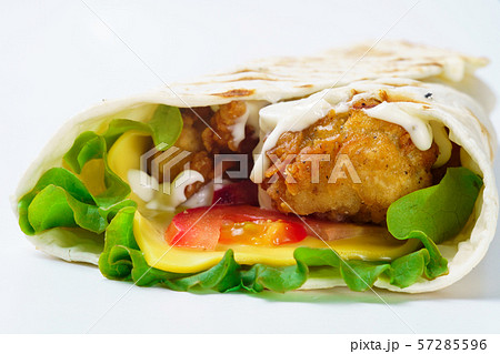 Grilled chicken burrito with vegetables on white background 57285596
