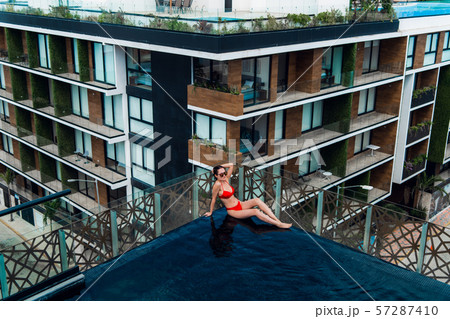 woman lying on a lounger by the pool at the hotel. 57287410